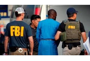 FBI agents apprehend a suspect linked to a raid on an FBI office, highlighting the agency's global operations.